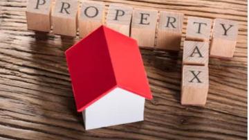 Wood play blocks spelling "Property Tax"